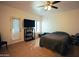 Carpeted bedroom featuring a ceiling fan, large windows, access to balcony, and media center at 3150 E Beardsley Rd # 1105, Phoenix, AZ 85050