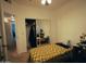 Bedroom features carpet, closet with mirror doors, and desk with chair at 3150 E Beardsley Rd # 1105, Phoenix, AZ 85050