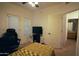 Carpeted bedroom with a window and access to an ensuite bathroom and a gaming chair at 3150 E Beardsley Rd # 1105, Phoenix, AZ 85050