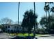 Picturesque view of a residential community with well-manicured landscaping and palm trees under a bright, sunny sky at 3150 E Beardsley Rd # 1105, Phoenix, AZ 85050