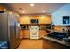 Kitchen featuring stainless steel appliances, light wooden cabinets, and granite countertops at 3150 E Beardsley Rd # 1105, Phoenix, AZ 85050