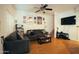 A living room featuring a large gray sofa and a flat screen television at 3150 E Beardsley Rd # 1105, Phoenix, AZ 85050