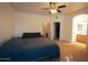 A spacious main bedroom suite featuring neutral carpeting, a ceiling fan, and ensuite bathroom access at 3150 E Beardsley Rd # 1105, Phoenix, AZ 85050