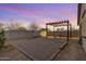 The backyard offers a pergola with string lights, a sand area, and block fencing at 35751 N Bandolier Dr, San Tan Valley, AZ 85144