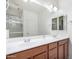 Bathroom features a double sink vanity, a large mirror, and a shower with glass doors at 35751 N Bandolier Dr, San Tan Valley, AZ 85144