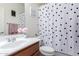 Well-lit bathroom features modern vanity with stylish polka-dot shower curtain at 35751 N Bandolier Dr, San Tan Valley, AZ 85144