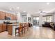 The living room flows seamlessly into the kitchen, featuring tile flooring, a ceiling fan, and a sliding glass door at 35751 N Bandolier Dr, San Tan Valley, AZ 85144