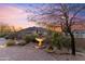 Beautiful desert landscaping with a stone fountain and a sunset background at 37170 N Granite Creek Ln, Carefree, AZ 85377
