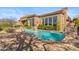 Backyard showcasing a sparkling pool with stone accents, lush landscaping, and a spacious patio area at 37170 N Granite Creek Ln, Carefree, AZ 85377