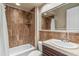 Bathroom featuring neutral-toned tiling, a tub, and a vanity with sink, offering a calming space at 37170 N Granite Creek Ln, Carefree, AZ 85377