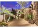Charming courtyard featuring a stone fountain, lush greenery, and brick-paved pathway at 37170 N Granite Creek Ln, Carefree, AZ 85377