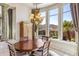 Charming dining room features a decorative chandelier and views of the outdoor landscape at 37170 N Granite Creek Ln, Carefree, AZ 85377