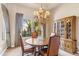 Elegant dining room with wood table, chandelier, and view of lush landscaping at 37170 N Granite Creek Ln, Carefree, AZ 85377