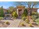 Beautiful entrance featuring a private gate, desert landscaping, and charming architecture at 37170 N Granite Creek Ln, Carefree, AZ 85377