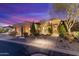 Exterior of home featuring manicured landscaping, lighted walkway, and ample three car garage at 37170 N Granite Creek Ln, Carefree, AZ 85377