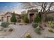 Stunning desert home featuring a landscaped front yard and private gated entrance at 37170 N Granite Creek Ln, Carefree, AZ 85377