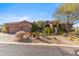 Beautiful front exterior showcasing desert landscaping, mature trees, and a large driveway at 37170 N Granite Creek Ln, Carefree, AZ 85377