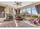 Bright living room with fireplace, ample natural light, and comfortable seating at 37170 N Granite Creek Ln, Carefree, AZ 85377