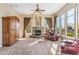 Spacious living room with a stone fireplace, plush seating, and views of the surrounding landscape at 37170 N Granite Creek Ln, Carefree, AZ 85377