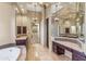 Spacious main bathroom featuring dual vanities, ample lighting, and walk in closet access at 37170 N Granite Creek Ln, Carefree, AZ 85377