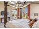 Bright main bedroom with a four-poster bed, balcony access, and large windows at 37170 N Granite Creek Ln, Carefree, AZ 85377