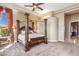 Serene main bedroom with a four-poster bed, tray ceiling, and comfortable ambiance at 37170 N Granite Creek Ln, Carefree, AZ 85377