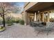 Beautiful outdoor patio with desert landscaping, a seating area, and a sunset sky at 37170 N Granite Creek Ln, Carefree, AZ 85377