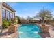 Stunning pool features elegant stonework, lush greenery, and tranquil water features for relaxation at 37170 N Granite Creek Ln, Carefree, AZ 85377