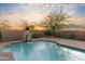 Sparkling backyard pool featuring stone waterfall accents amidst desert landscaping at 37170 N Granite Creek Ln, Carefree, AZ 85377