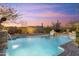 Stunning pool with waterfall features and desert landscaping at 37170 N Granite Creek Ln, Carefree, AZ 85377