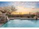 Backyard pool featuring stone accents, desert landscape views, and waterfall feature at 37170 N Granite Creek Ln, Carefree, AZ 85377