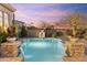 Gorgeous pool featuring brick accents, desert landscaping, and waterfall features at 37170 N Granite Creek Ln, Carefree, AZ 85377