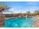 Beautiful pool features stone accents and serene water features against a backdrop of desert landscaping at 37170 N Granite Creek Ln, Carefree, AZ 85377