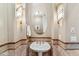 Elegant powder room features sconce lighting, decorative mirror, and pedestal sink at 37170 N Granite Creek Ln, Carefree, AZ 85377