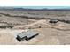 An aerial shot shows a cozy home and adjacent outbuilding, nestled within a vast, rural desert landscape at 40715 W Georgia Ave, Tonopah, AZ 85354