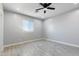 Bright bedroom with wood-look tile flooring and a large window for natural light at 40715 W Georgia Ave, Tonopah, AZ 85354