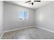 A bedroom features a ceiling fan, gray walls and a window with a beautiful view at 40715 W Georgia Ave, Tonopah, AZ 85354