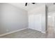 Neutral bedroom featuring gray floors, closet, and a view to ensuite bathroom at 40715 W Georgia Ave, Tonopah, AZ 85354