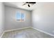 A bedroom features gray walls and a ceiling fan with a desert view seen from the window at 40715 W Georgia Ave, Tonopah, AZ 85354