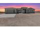 Charming one-story home with a modern garage door and a large, sunny front yard at 40715 W Georgia Ave, Tonopah, AZ 85354