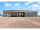 The back of the home shows a large covered patio for outdoor entertaining, and serene desert surroundings at 40715 W Georgia Ave, Tonopah, AZ 85354