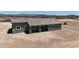 The aerial view reveals the covered back patio and desert scenery, promising tranquil outdoor living at 40715 W Georgia Ave, Tonopah, AZ 85354