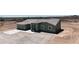 The view captures a spacious backyard featuring a covered patio, blending indoor/outdoor enjoyment within a desert setting at 40715 W Georgia Ave, Tonopah, AZ 85354