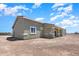 The back of the home shows a spacious yard with a covered patio, merging indoor relaxation with desert serenity at 40715 W Georgia Ave, Tonopah, AZ 85354