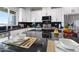 A kitchen island features granite countertops with modern appliances and breakfast bar at 40715 W Georgia Ave, Tonopah, AZ 85354