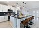 Beautiful kitchen showcases a large island with seating, white cabinets, and stainless appliances at 40715 W Georgia Ave, Tonopah, AZ 85354