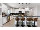 Spacious kitchen with granite countertops, white cabinets, stainless appliances, and a breakfast bar at 40715 W Georgia Ave, Tonopah, AZ 85354