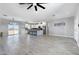 Open-concept living room leads to kitchen and dining area with great natural lighting at 40715 W Georgia Ave, Tonopah, AZ 85354