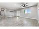 Large living room features tile flooring, a ceiling fan, and a modern front door at 40715 W Georgia Ave, Tonopah, AZ 85354
