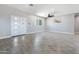 Open floor plan featuring gray floors, ceiling fan, and double front doors at 40715 W Georgia Ave, Tonopah, AZ 85354